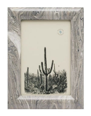 Framed monochrome artwork of a desert landscape with multiple tall cacti, hand-painted with intricate detail. The frame boasts a Pigeon and Poodle Gray Swirled Lacquered Resin Ashland Frame, 4 x 6 design crafted from lacquered resin.