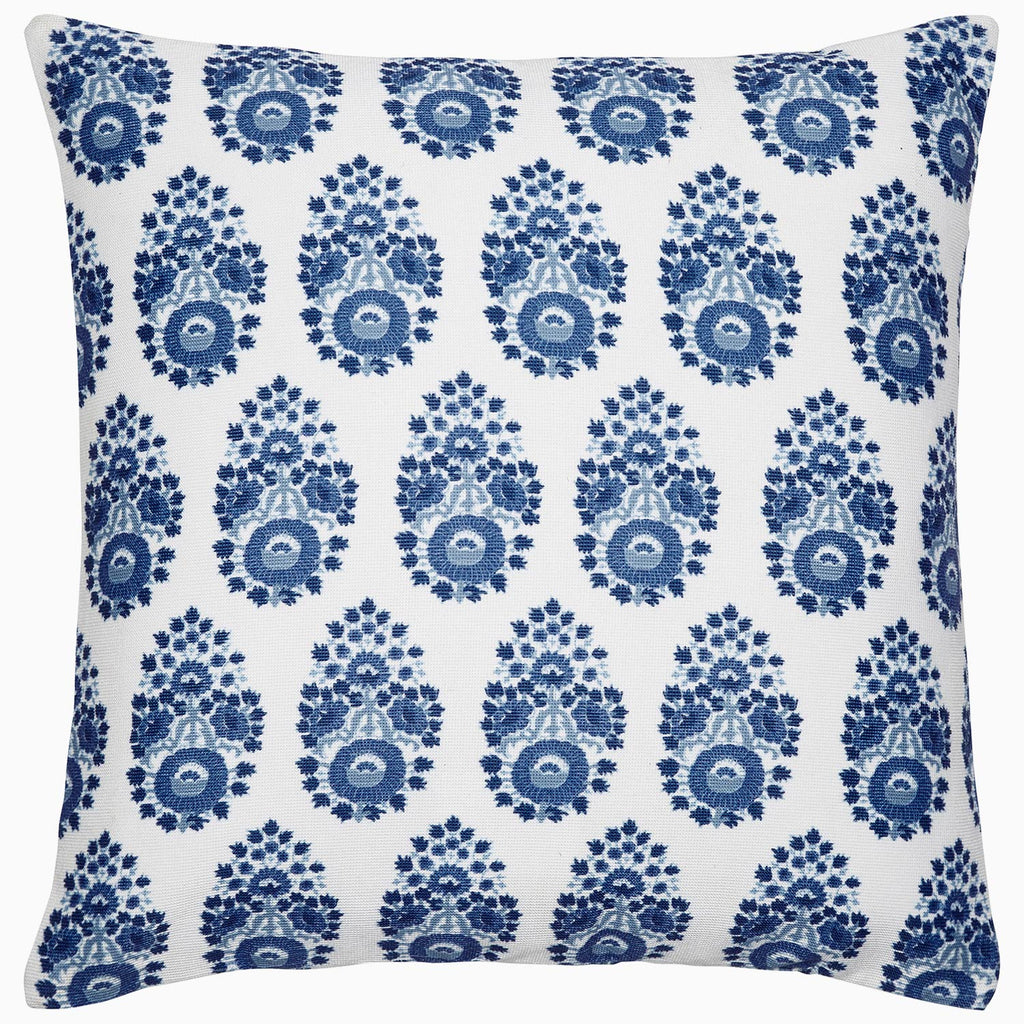 The John Robshaw Adira Indigo Outdoor Pillow features a white background with a repeating blue floral pattern that evokes traditional indigo designs, adding an elegant touch to any area.