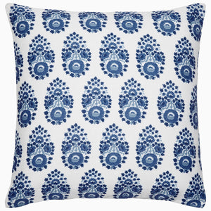 The John Robshaw Adira Indigo Outdoor Pillow features a white background with a repeating blue floral pattern that evokes traditional indigo designs, adding an elegant touch to any area.