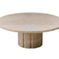 A round, beige marble table with a thick, cylindrical base featuring vertical grooves exudes timeless elegance. Its classical base highlights the raw travertine finish, creating a stunning centerpiece for any room.