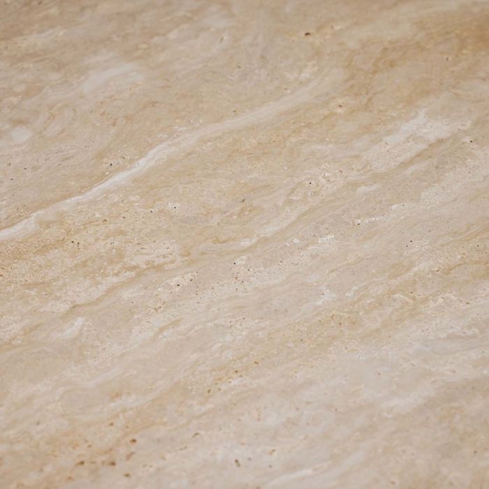 A close-up of a beige marble surface with wavy, natural patterns, reminiscent of raw travertine, exuding timeless elegance like that of the Amerigo Cocktail Table.