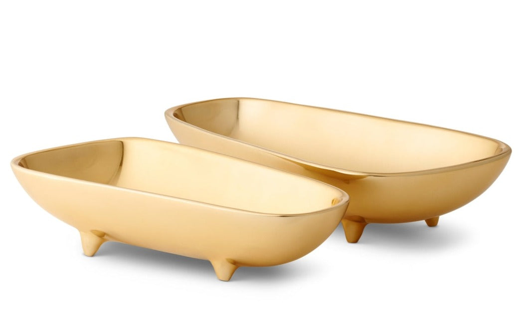 Two identical gold-colored, boat-shaped footed bowls from the AERIN Valerio Footed Bowl Collection, perfect for serving snacks while entertaining, are arranged side by side.