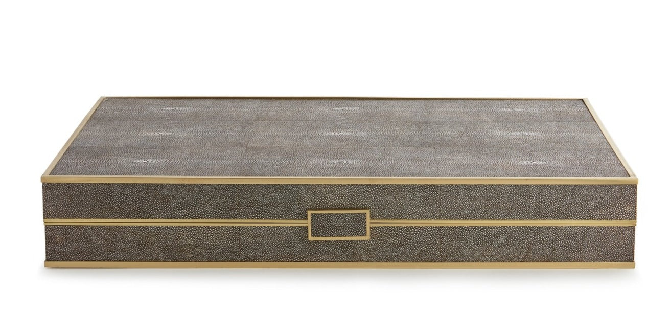 A rectangular grey and gold box with a shagreen finish features a textured surface and a rectangular handle in the center of the front. Perfect for storing your favorite board games like the AERIN Shagreen Backgammon Set, Chocolate.