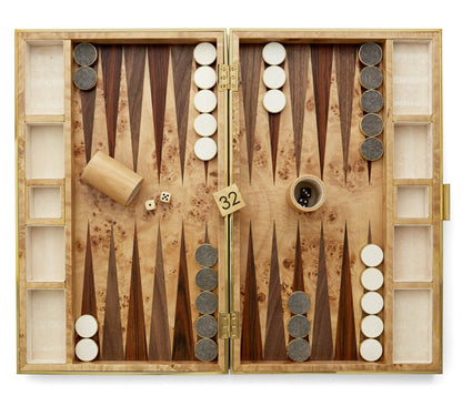 A AERIN Shagreen Backgammon Set, Chocolate with pieces set up for play, a shagreen finish lending it a luxurious touch, a doubling cube showing 32, a pair of dice, and a dice cup on the board.