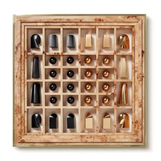 A wooden box containing an AERIN Shagreen Chess Set with complete, contemporary chess pieces in sleek black and gold.