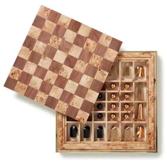 An open chess board made of wood, showcasing a checkered pattern lid partially lifted, revealing contemporary chess pieces stored neatly inside compartments. This luxurious AERIN Shagreen Chess Set is perfect for both display and play, blending timeless elegance with modern design.