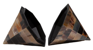 The Triangle Cone Box, Brown Horn consists of two triangular, multi-toned geometric boxes with removable lids. The surfaces are composed of alternating light and dark rectangular segments, resembling a sophisticated horn veneer design.