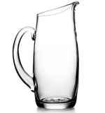 A clear, empty glass pitcher with a wide handle and a spout designed for pouring, this versatile Simon Pearce Addison Pitcher is a bestseller and an ideal gift for any occasion.