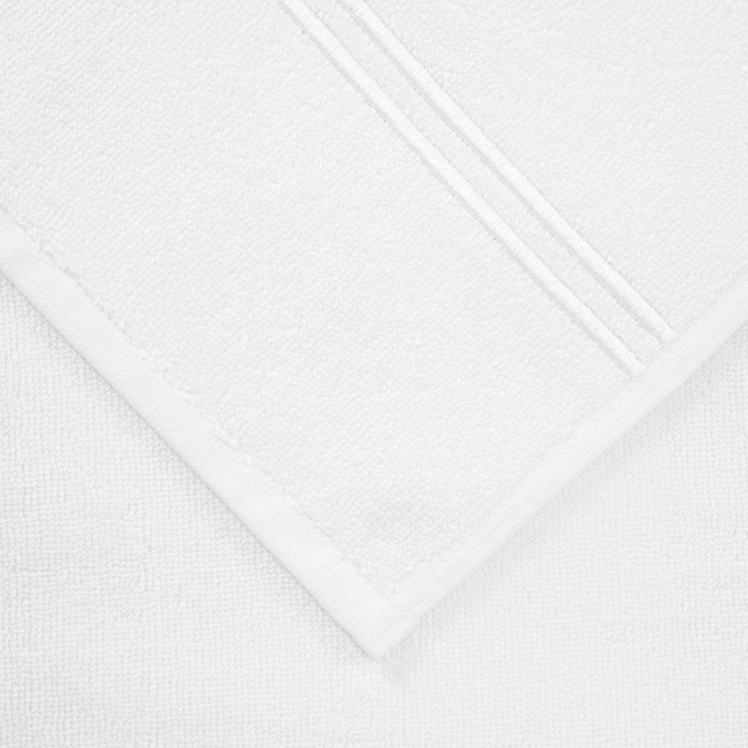 A close-up image of a Frette Classic Bath Collection, White/White towel with a textured weave and finished edges from our bathroom collection.