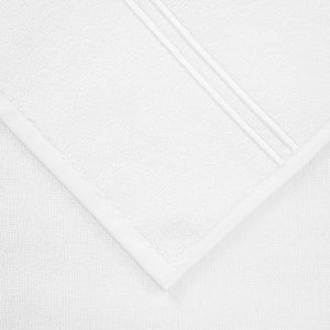 A close-up image of a Frette Classic Bath Collection, White/White towel with a textured weave and finished edges from our bathroom collection.