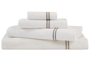 A neatly stacked set of four white towels from the Frette Classic Bath Collection, White/Khaki, featuring two thin horizontal brown stripes on each towel. Made of highly absorbent cotton terry, these towels also showcase subtle double border embroidery for an added touch of elegance.