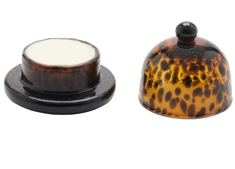 The Blue Pheasant Andrew Butter Dish, Tortoise boasts a tortoiseshell pattern on its hand-blown glass lid. The lid rests to the right, showcasing the durable butter dish underneath.