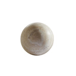 A Travertine Sphere with a smooth, light brown surface and subtle variations in color. Sold individually.