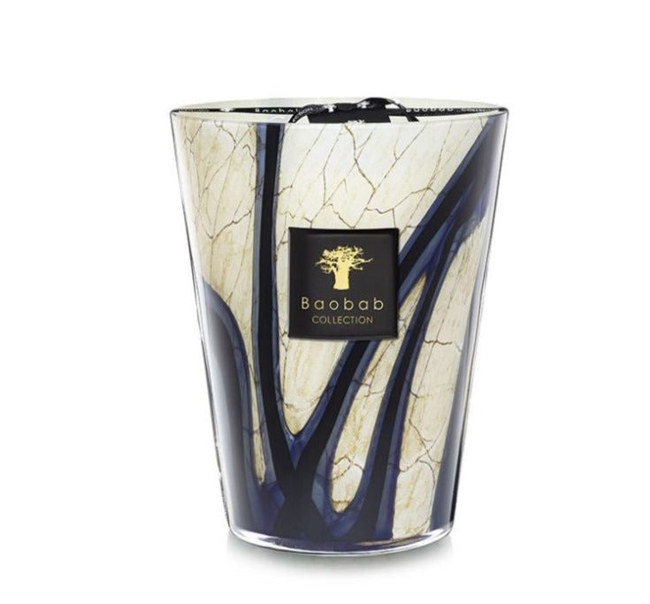 A Baobab Collection Stones Lazuli Candle featuring a marbled design with blue lines, a gold logo label on the front, and infused with hints of cardamom for a touch of aromatic elegance.