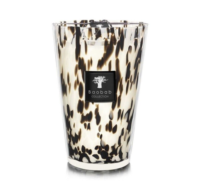 A tall decorative, scented candle with a black-spotted design on a white background, labeled "Baobab Collection Pearls Black Candle.