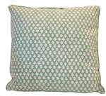 The Burma Meadow Outdoor Pillow is a custom-made square pillow with a green background, small white leaf pattern, and green piped edge, crafted from premium materials for lasting comfort and style.