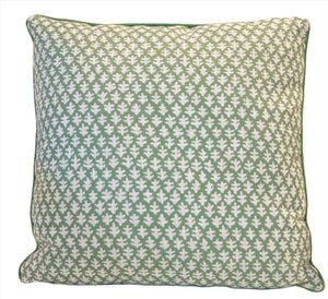 The Burma Meadow Outdoor Pillow is a custom-made square pillow with a green background, small white leaf pattern, and green piped edge, crafted from premium materials for lasting comfort and style.