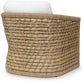 The Capitola Lounge Chair is a square-shaped, woven rattan chair with a grid pattern made from natural seagrass, topped with a white cushion.