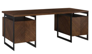 The Barstock Desk is a modern wooden desk with a dark finish, a herringbone veneered top, two box-style cabinets on each side, and black metal cantilever legs.