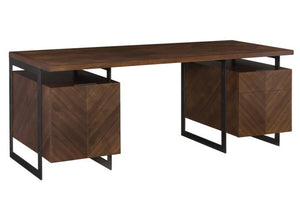 The Barstock Desk is a modern wooden desk with a dark finish and herringbone veneered top, featuring two sets of drawers on each side and supported by a sleek black metal frame.