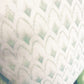 A close-up of the Arrowhead Rainwashed Pillow showcases its repeating scalloped pattern in light green and white, crafted with premium materials and careful attention to detail.
