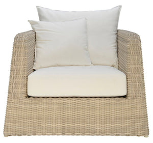 The Zeya Outdoor Lounge Chair features a beige, weather-resistant wicker frame with a white seat cushion and two white throw pillows, all viewed from the front.