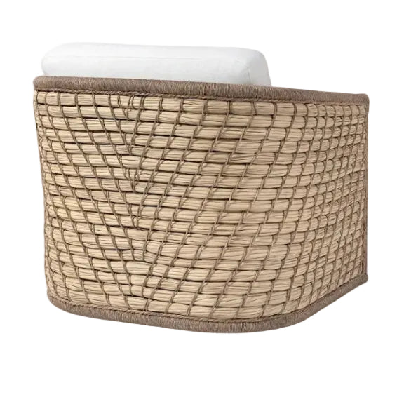 The Capitola Swivel Lounge Chair features a durable powder-coated aluminum frame, woven rattan, a curved back, and a white seat cushion, shown from an angled rear view.