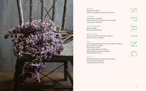 A bundle of purple flowers rests on a rustic wooden chair. To the right, a spring-themed menu inspired by Lemon Apron Cookbook is listed with various dishes under categories such as Breakfast, Appetizers, Soup and Simmer, Salad and Side, Main, and Dessert.