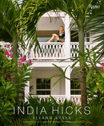 A woman sits on a white balcony surrounded by lush greenery and flowers. The text reads "India Hicks: Island Style," capturing the essence of bohemian decorating style with a foreword by the Prince of Wales.