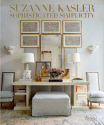 Cover of "Suzanne Kasler: Sophisticated Simplicity" by Suzanne Kasler. A stylish room showcases interior design excellence with a beige desk, two chairs, a bench, two lamps, and framed art pieces on a light-colored wall. Perfect for elegant family homes or oceanfront estates seeking refined simplicity.