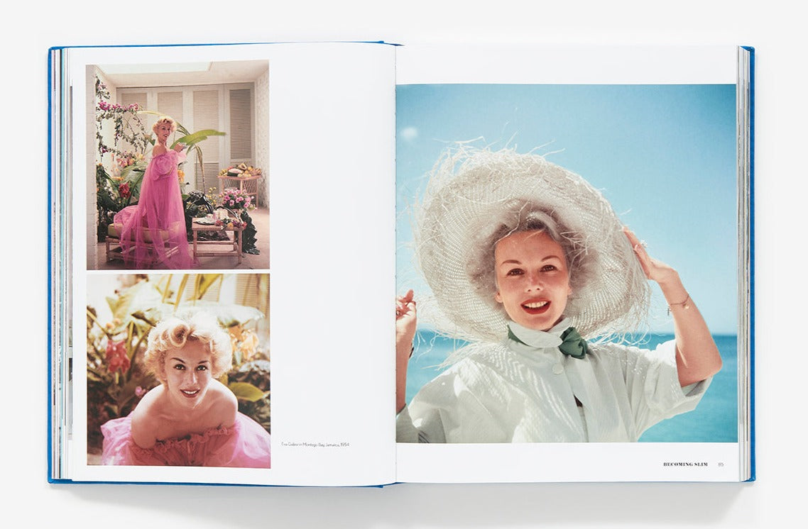 An open book displaying three photographs of a woman in different poses and outfits, including a large straw hat, set against colorful backgrounds—a nod to the style of Slim Aarons: The Essential Collection.