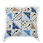 Introducing the Sunnyjim Batik Outdoor Pillow, a 22x22 square pillow with a striking geometric design in blue, brown, and white hues. Featuring bold triangle sections and charming pom-pom trim along the edges, it’s perfect for adding custom style and visual interest to your outdoor space.