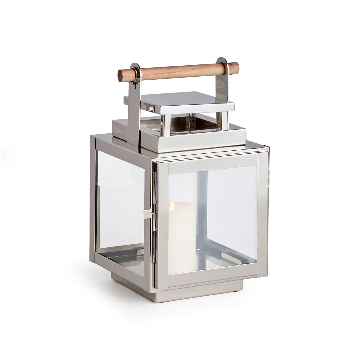 The Adwin Outdoor Lantern features a sleek chrome metal and glass design with a teak handle and holds an unlit white pillar candle inside.