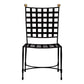 The Janus et Cie Amalfi Dining Side Chair in Slate features a black grid-patterned backrest and seat, stainless steel frames, and two gold spheres—perfect for stylish outdoor settings.