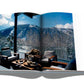 A rustic-chic Assouline book with a view of mountains and a chair, inspired by Aspen Style.