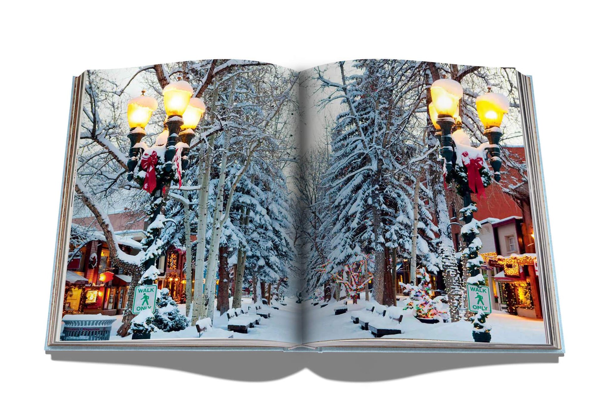 A book with a picture of a snow-covered street in Assouline's Aspen Style.