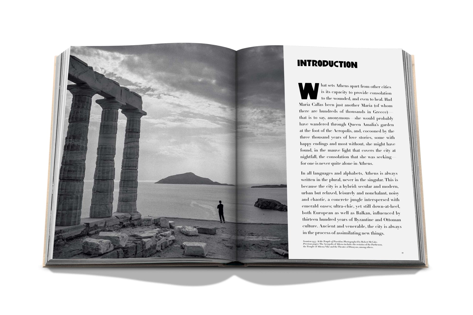 A black and white photo of a book with a picture of a pillar inspired by Athens culture, featuring the Athens Riviera by Assouline.