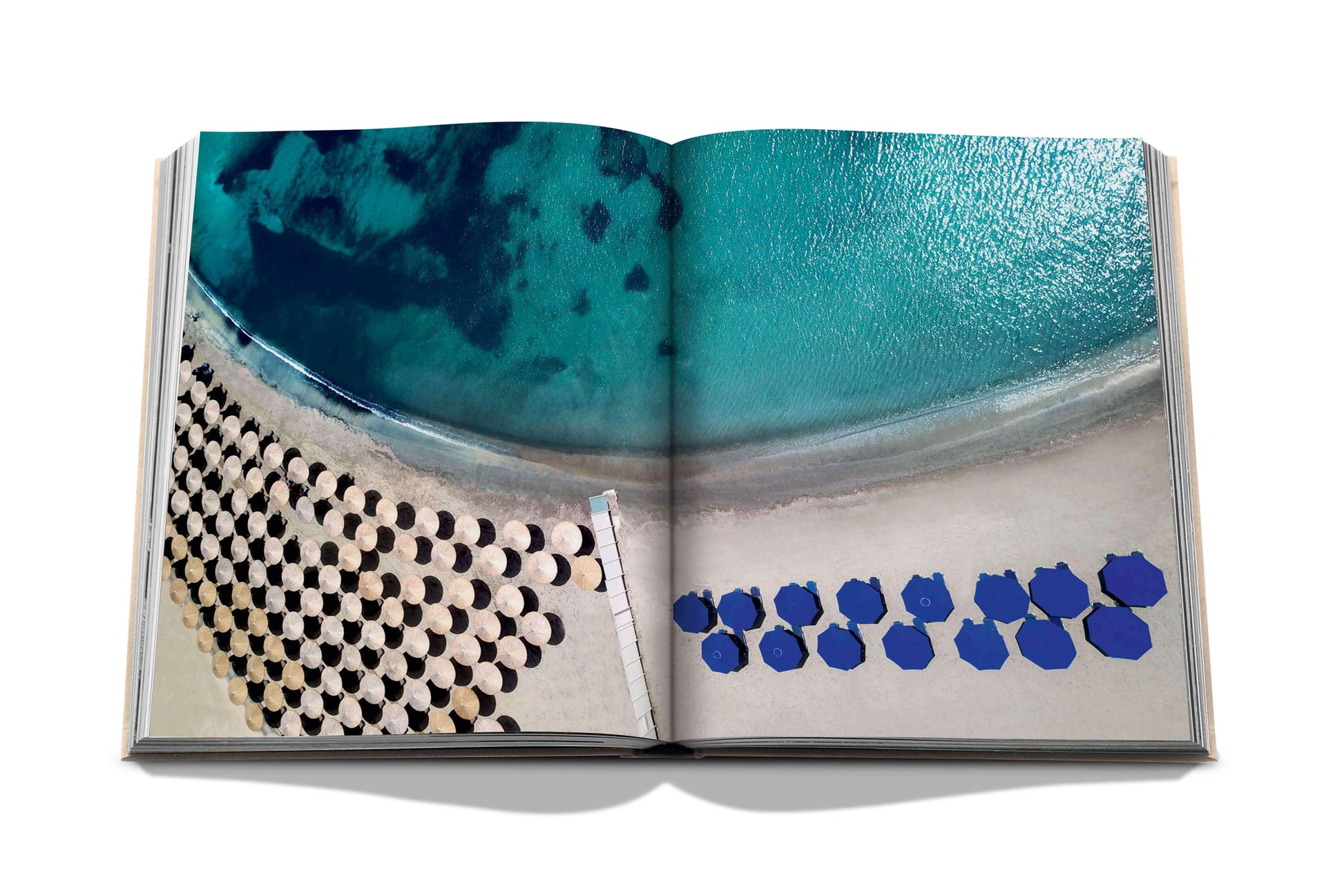 An Athens Riviera book by Assouline featuring an image of blue chairs on a beach.