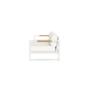 Side view of the Breeze XL Sofa in White Panama Blanco, featuring plush white seat and back cushions and light wood teak accents, set against a plain white background.