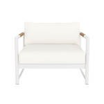The Breeze XL Lounge Chair in White Panama Blanco features a modern white design with teak-accented armrests, a cushioned seat and backrest, and is shown from the front against a plain white background.