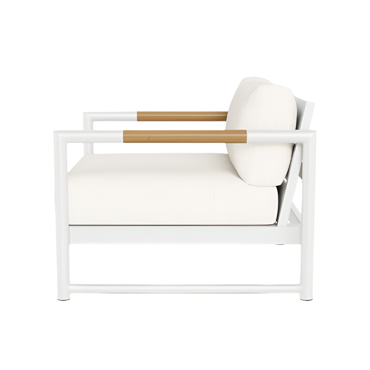 Side view of the Breeze XL Lounge Chair in White Panama Blanco, showcasing light wood armrests, a thick white cushion and backrest, and sleek aluminum construction.
