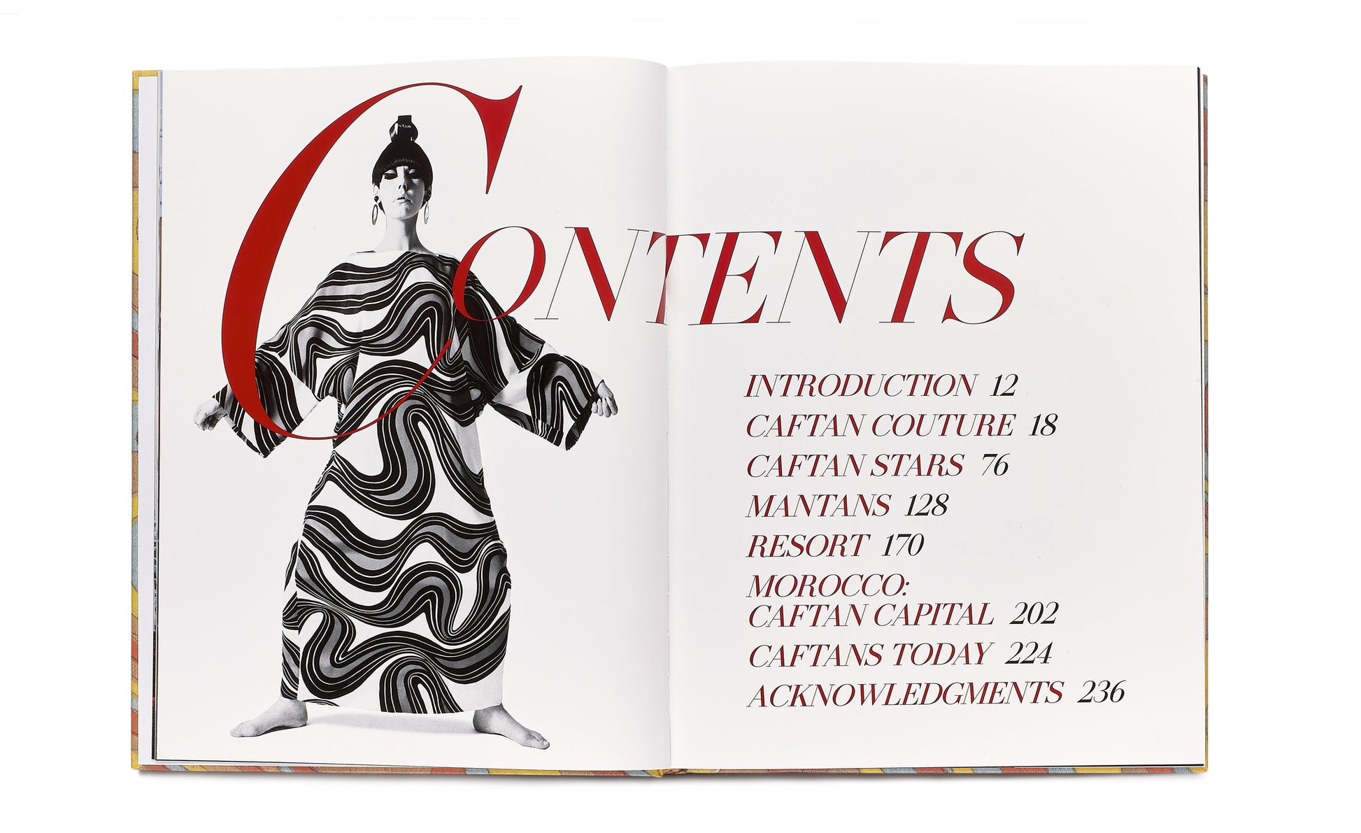 Open book displaying a contents page with a black and white photo of a person wearing a patterned outfit, featuring sections titled Introduction, Caftan Couture, Caftan Stars, Mantans, Resort, Morocco, Caftan Capital, Caftans Today, and Acknowledgments.