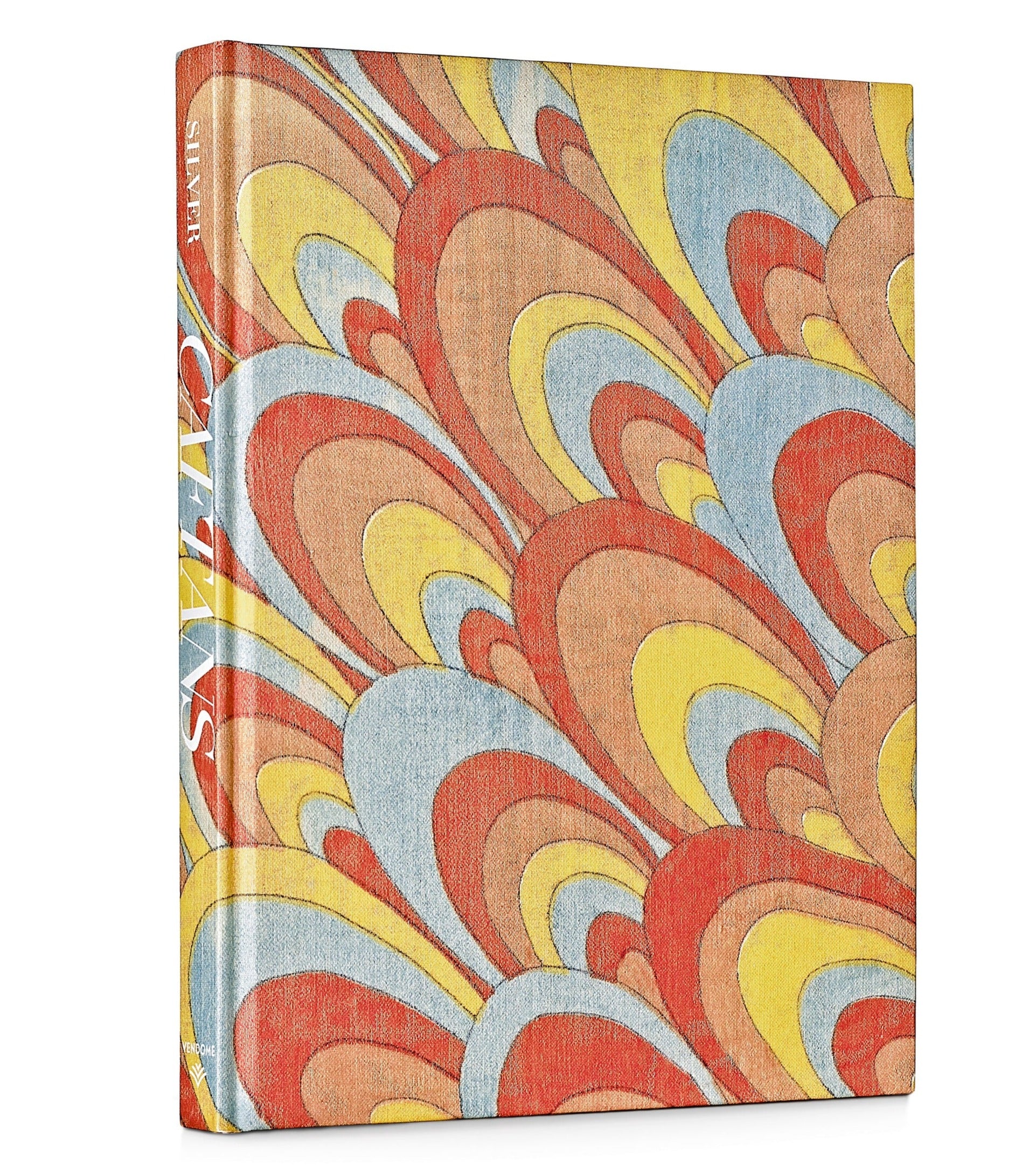 A hardcover book with a vibrant cover featuring a marbled pattern of red, yellow, blue, and beige swirls rests elegantly beside a luxurious caftan. The title "Caftans: From Classical to Camp" is visible on the spine, inviting readers to dive into its Resort-inspired tales.