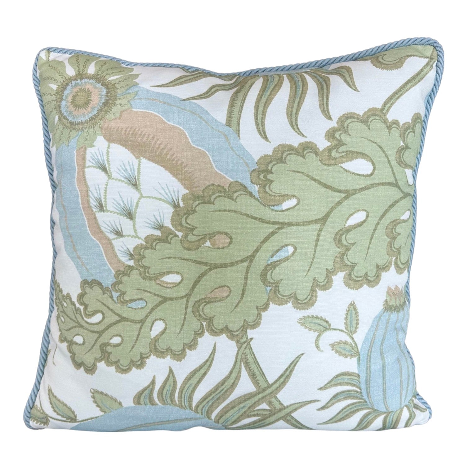 The Carnival Celeste Outdoor Pillow features a blue, green, and beige botanical leaf pattern on white, accented with light blue piping. Expertly crafted from premium materials, it adds a touch of luxury to your custom pillow collection.