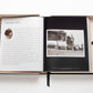 Open photo book with text on the left page and a black-and-white image of a storefront labeled "Chanel" on the right page, bound with a black ribbon bookmark, capturing the essence of luxury fashion and iconic looks in *The Impossible Collection: Chanel*.