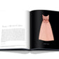 An open book displaying a text page titled "NOËL À MONTE CARLO" on the left and a photograph of a pink sleeveless dress, part of the Dior: Marc Bohan collection, captured in original photography by Laziz Hamani, on the right.