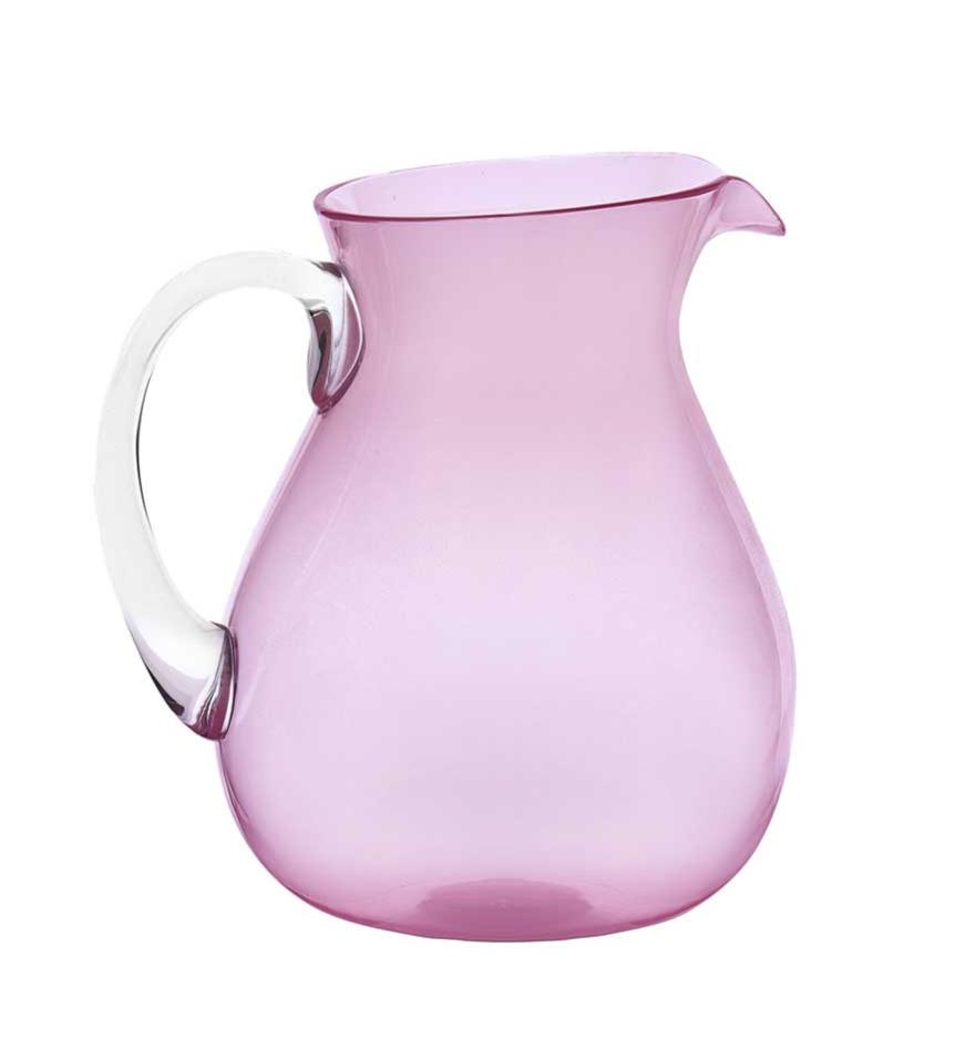 A pink acrylic pitcher with a transparent handle, part of the Memento Acrylic Pink Collection, is elegantly positioned against a white background.