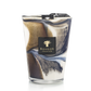 A decorative scented candle with a marbled design in brown, white, and blue colors. Infused with the essence of sea salt, the label reads "Baobab Collection Delta Nil Candle.