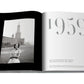 An open book displays a black and white photo of a smiling woman in front of a clock tower, with text that reads "1959." Pages detail haute couture from Spring-Summer and Autumn-Winter 1959, featuring iconic designers like Yves Saint Laurent and Dior: Yves Saint Laurent.