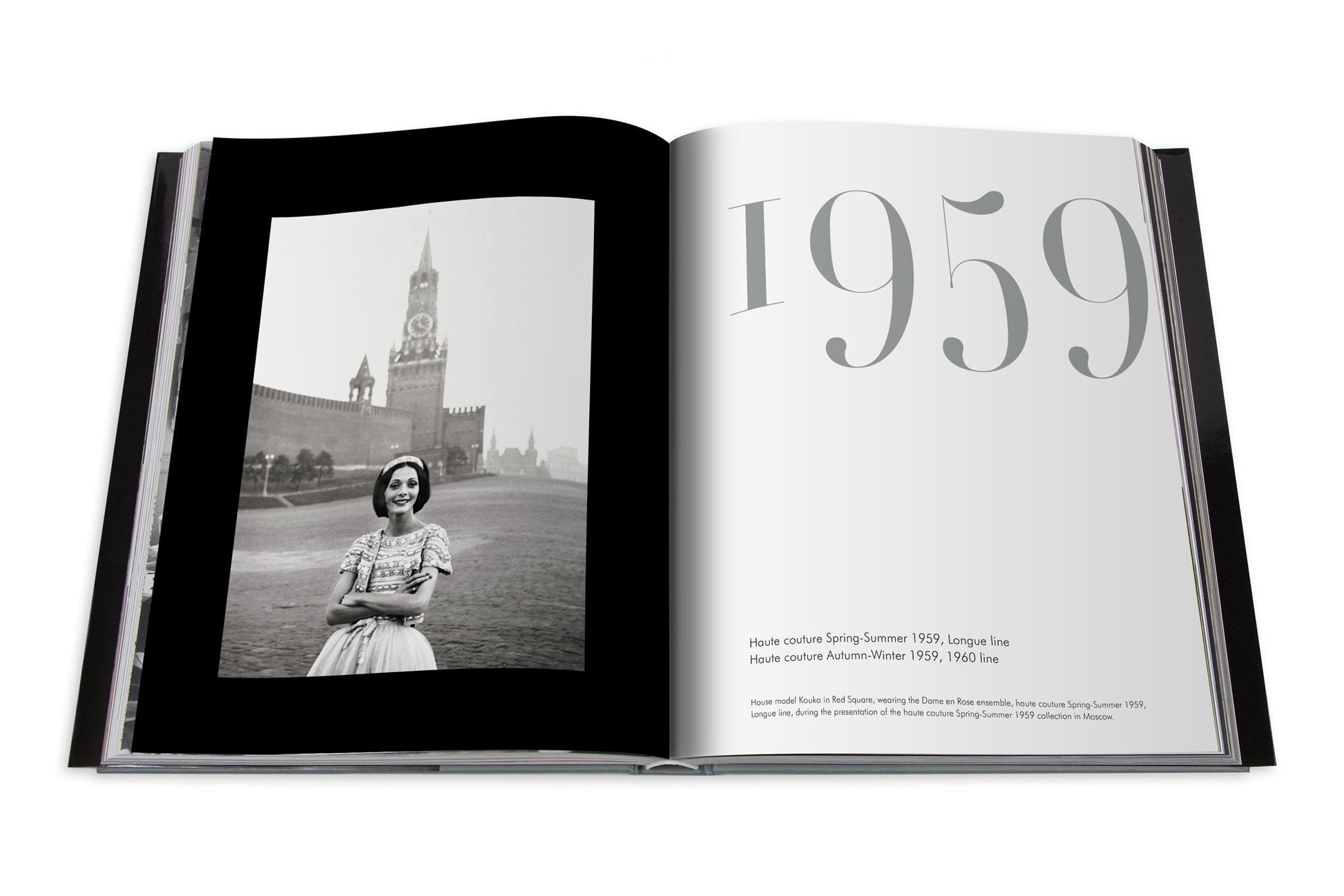 An open book displays a black and white photo of a smiling woman in front of a clock tower, with text that reads "1959." Pages detail haute couture from Spring-Summer and Autumn-Winter 1959, featuring iconic designers like Yves Saint Laurent and Dior: Yves Saint Laurent.